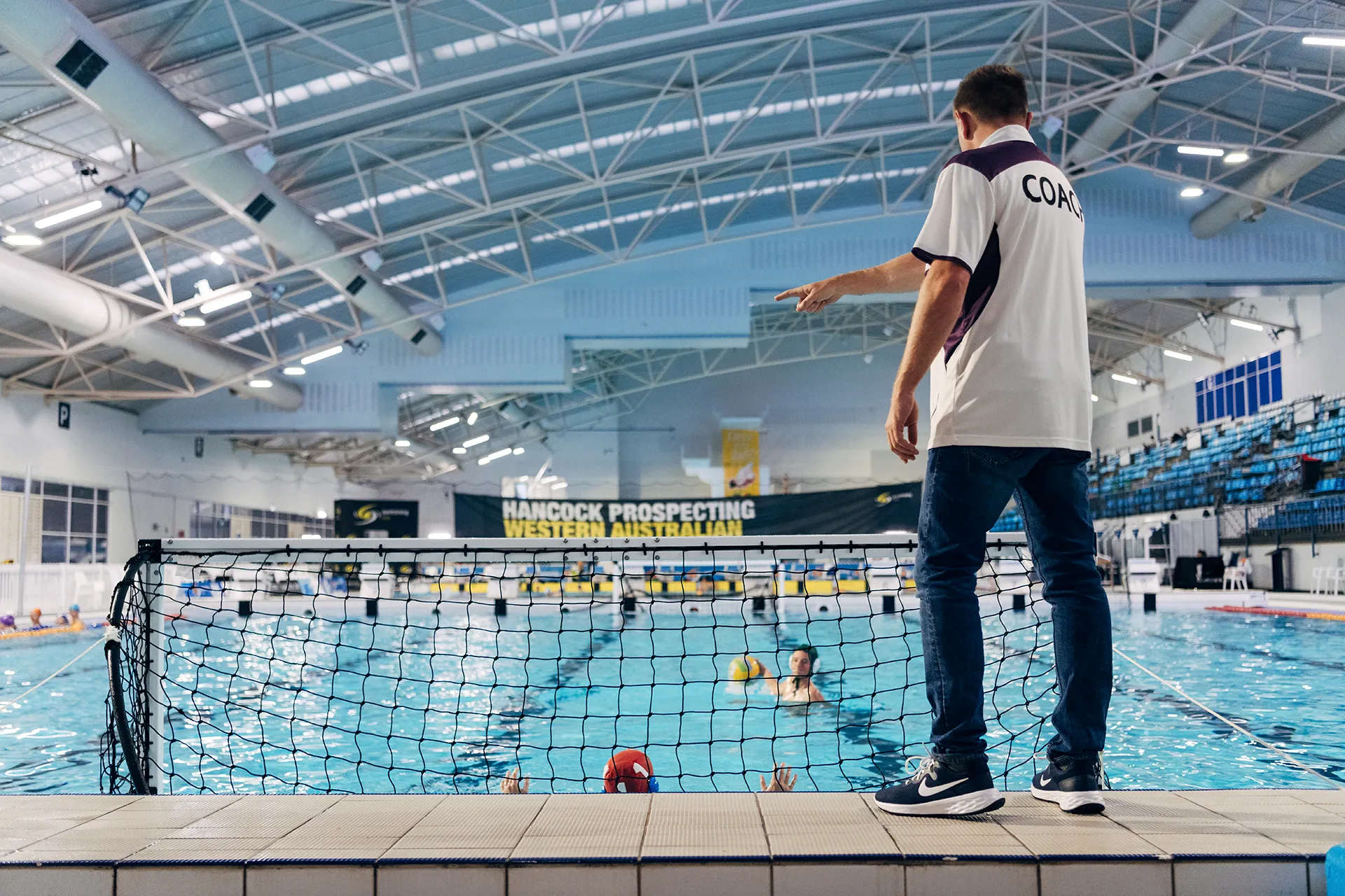 Coach directing waterpolo players